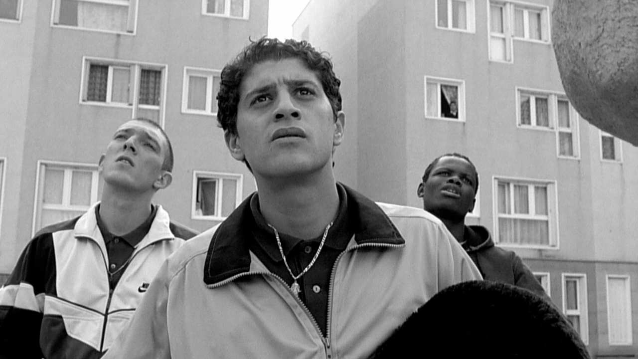 three young men standing together and looking up